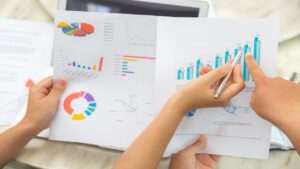 group of business people pointing at business document during me