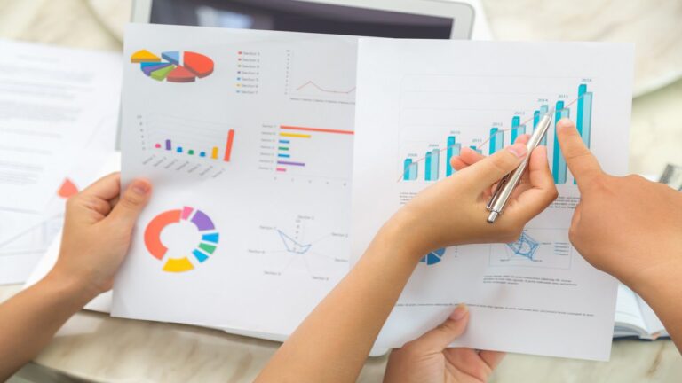 group of business people pointing at business document during me